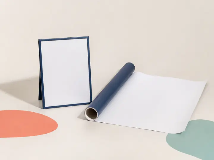 Blank tabletop sign and partially unrolled poster